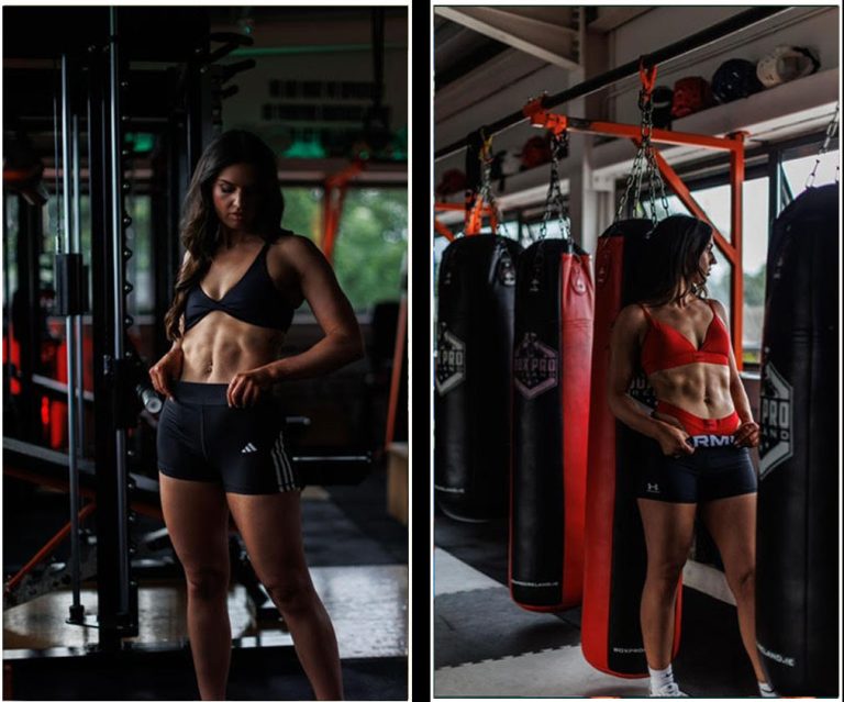 Two fit women posing in athletic wear, one by gym equipment and the other near punching bags.
